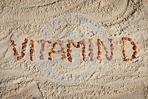 Inscription vitamin D on sand at beach. Prevention of vitamin D deficiency