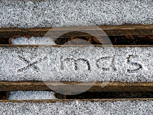 The inscription xmas on the snow. Christmas background.