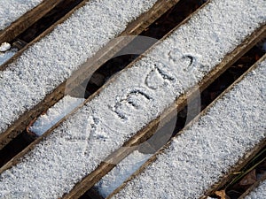 The inscription xmas on the snow. Christmas background.