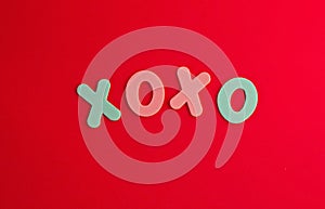 The inscription xo xo from colored letters on a red background. The concept of Valentine\'s day, love, dating and wedding.