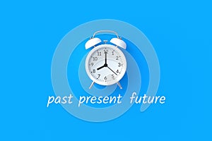 Inscriptions past, present, future under alarm clock. Time concept