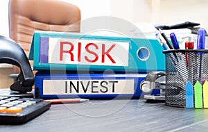 Inscriptions on RISK and INVEST folders. Business concept