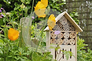 An insect hotel or bee hotel in a summer garden