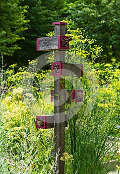 Insect hotel in a summer garden during day