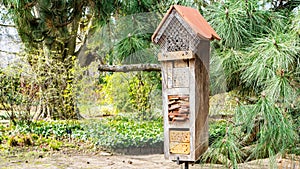 Insect house close up photo with copy space. Insect hotel with many houses for various animals that protect the home garden from