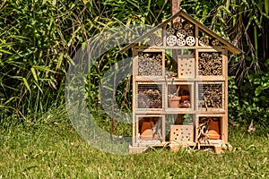 Insect house in the garden. Bug hotel at the park with plants in Switzerland