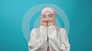 Insecure frightened Young Muslim woman in hijab biting nails, feeling worried nervous about serious troubles, stress and