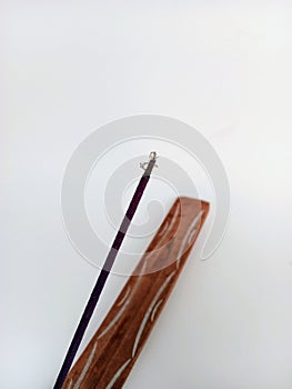 Insense stick and holder on a white background