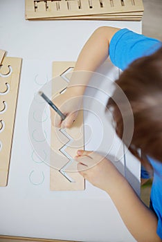 Insert templates for preparing the preschooler`s hands for writing. Early development concept. The child is learning to write