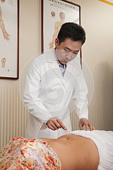 Inserting Acupuncture Needles photo