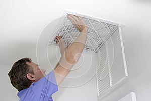 Inserting New Air Filter in Ceiling