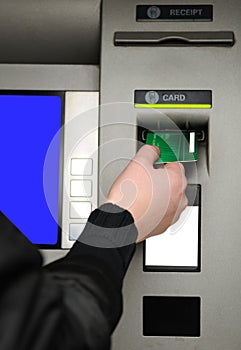 Inserting plastic card visa into ATM