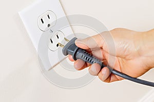 Inserting Power Cord Receptacle in wall outlet photo