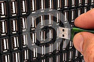 Hand inserting USB flash drive in one of many sockets