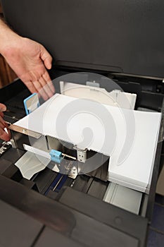 Inserts a paper A4 into a laser copier