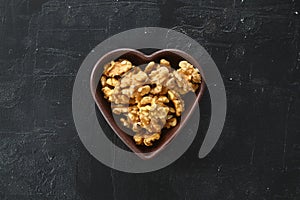 Inshell walnuts in a heart-shaped plate. Heart Nuts, Heart Health Products, Structured Walnuts Healthy food protein