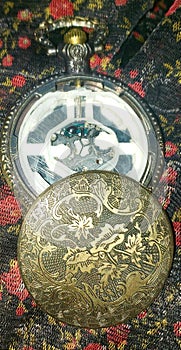 Inside of the back of a golden-pewter pocketwatch