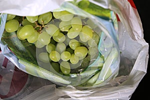 Inside a blurred grocery bag - fresh green grapes