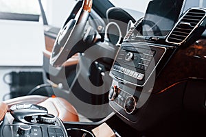 Inside of brand new modern black automobile. Front control panel