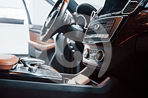 Inside of brand new modern black automobile. Front control panel