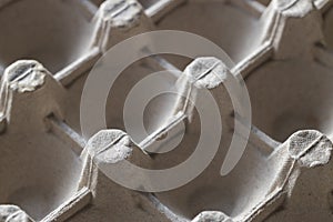 The inside of the cage of the container for eggs close-up. The texture of the paper container for eggs