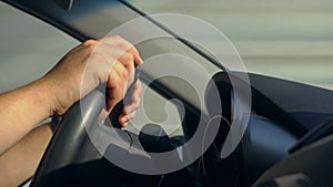 Inside a Car. A Man`s Hands on the Steering Wheel