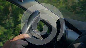 Inside a Car. A Man`s Hands on the Steering Wheel