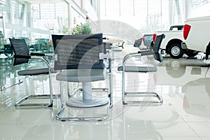 Inside car showroom interior with group of chairs and table photo