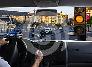 Inside car view of a orange traffic light