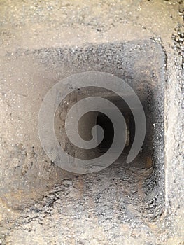 Inside chimney whose walls are covered with soot and tar