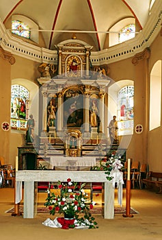 Inside of a church with altar and flower