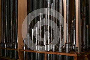 Inside a church organ, register with reed pipes from metal with tuning wire and resonator, musical instrument photo