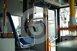 Inside of a city bus with empty passengers seats