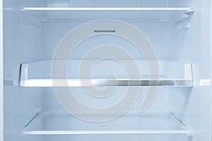 Inside of clean and empty refrigerator with shelves. background for health or diet concept