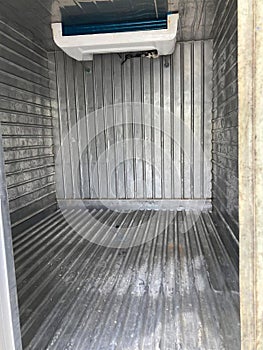 Inside of a container on the back of a truck in the garage