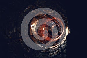 Inside cooling tower or smokestack, big old tunnel view, industrial round tube as abstract way to end background