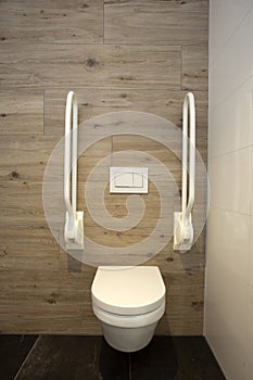 Inside disable toilet. toilet with grab bars for senior or a handicapped person,disable concept. modern design