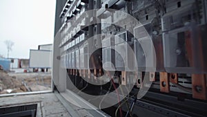 Inside of electrical control panel with multiple switches, wires, short circuit protection devices, electricity meter