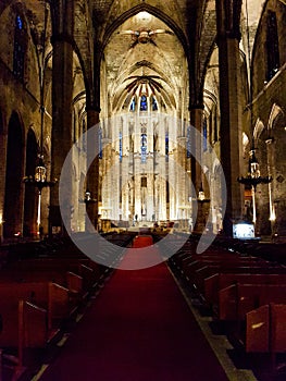 Inside empty church seats row red carpet indoor cathedral stones historic light altar shine religious Barcelona spain