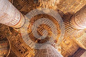 Inside Esna Temple, the imposing columns adorned with hieroglyphs stretch towards the ornate ceiling. photo