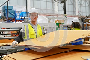 Inside a factory, industrial worker in action on machine.