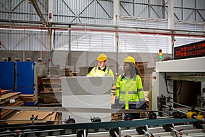 Inside a factory, industrial worker in action on machine.