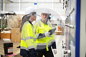 Inside a factory, industrial worker in action on machine.