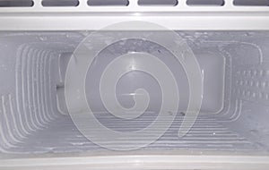 Inside the freezer of a refrigerator water vapor frozen on its walls / empty space in freeze