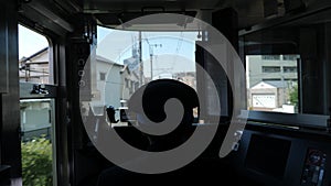 Inside front view of a train with a driver, Japan.