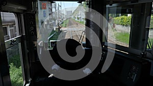 Inside front view of a train with a driver, Japan.