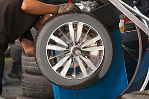 Inside a garage - changing wheels-tire during spinning wheel/Car wheel tire replacement - changing wheels-tires