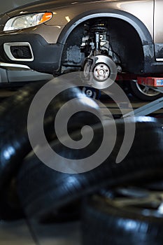 Inside a garage - modern car waiting for the mechanic