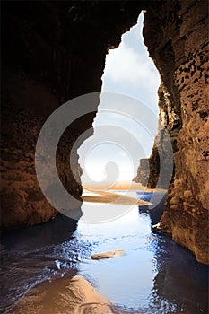Inside golden beach cliff cave