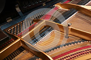 Inside a grand piano, metal frame, strings and mechanics of the old acoustic musical instrument, music themes, selected focus